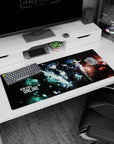 36x16 inches anime desk pad showing two back-to-back fighters, heroine with glowing sword and armored suit.