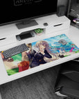 Winking silver-haired schoolgirl with sleepy cat in a park scene on 36x16 inches anime desk pad.