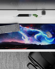 Glowing blues, violet haze, and ember-red sparks on a cosmic desk pad, 36x16 inches.