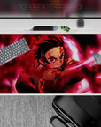 Demon Slayer desk pad showcasing Tanjiro Kamado in a powerful design, 40x20 inches, perfect for anime fans and gamers.