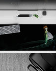 36x16 inches anime desk pad in inky blacks with green jacket and white top, calm intense late-night lab mood.
