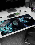Tanjiro from Demon Slayer in action on a 40x20 inch anime desk pad; vibrant water-breathing style in cool blues.