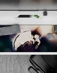 Moody 36x16 inches anime desk pad in smoky blues and charcoal shadows with soft bokeh night glow.