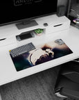 28x12 inches anime mouse pad showing a brooding boy in a loose white shirt, knees hugged close, hand near lips.