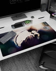 Sharp-eyed anime boy in a loose white shirt, knees drawn up, on a 40x20 inches desk pad.
