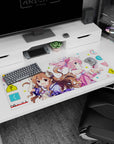 36x16 inches anime desk pad showing brunette with tiny horns smiling beside pink-haired girl in headphones.