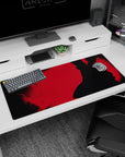 36x16 inches Itachi Uchiha desk pad, Naruto-inspired, cloak flowing in a quiet showdown scene with smoke.
