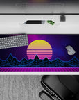 36x16 inches desk pad with synthwave design, blending glowing yellow sunset, neon blue mountains, and purple grid landscape for retro-futuristic flair.