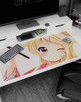 Winking blonde anime girl in yukata on desk pad 40x20 inches, pink blossoms and purple eye close-up.