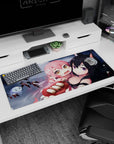 Pink-haired girl clinging to fox-eared black-haired anime girl desk pad 36x16 inches with drifting snow.