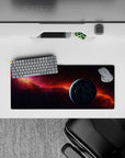Moody purple-to-midnight desk mouse pad 28x12 inches with fiery orange nebula for cozy late-night vibes.