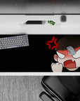 Black background with peach tones, sharp white eyes, and red anger mark desk pad, 36x16 inches.