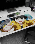 Winking anime girl in yellow hoodie flashing a peace sign on a 40x20 inches desk pad.