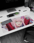 Artistic 36x16 inches desk pad featuring Zero Two from Darling in the Franxx, blending soft pink tones with her bold, unforgettable expression.