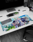 36x16 inches anime desk pad showing a black-cloaked fighter dashing as a pink-robed mage hovers above.