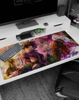 Wide-eyed helmeted explorer holding a tiny creature, blonde partner amazed, anime desk pad 40x20 inches.