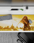 Sunset gold 36x16 inches anime desk pad, soft romantic fantasy mood with drifting light feathers.