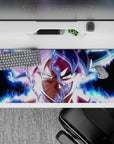 36x16 inches desk pad featuring Goku in Ultra Instinct, with radiant blue and white energy, perfect for fans of Dragon Ball Super’s greatest moments.