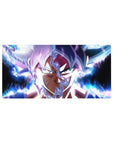 Mouse pad featuring Goku in Ultra Instinct, 32x16 inches, surrounded by glowing blue and white energy, perfect for any Dragon Ball fan.