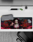 Anime mouse pad 32x12 inches featuring Nezuko with piercing pink eyes and fiery red background, perfect for desk setup.