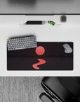 Tranquil 28x12 mouse pad with deep mountain shadows, a glowing red sun, and calm waters for a serene, mysterious desk vibe
