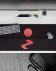 Serene 36x16 desk pad with a glowing red sun and reflective waters, creating a calming, mysterious atmosphere on your desk