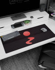 Calm 36x16 anime desk mat with deep mountain shadows, a glowing red sun, and calm waters, perfect for a tranquil and reflective workspace