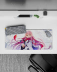 Dynamic 28x12 mouse pad with Zero Two’s flowing pink hair, fierce emerald eyes, and windswept background for anime charm