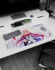 Bold 32x16 mouse pad with Zero Two’s fierce emerald eyes, flowing pink hair, and dynamic windswept background for charm