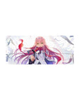 Bold 28x12 mouse pad featuring Zero Two’s emerald eyes, flowing pink hair, and windswept background for a powerful aesthetic