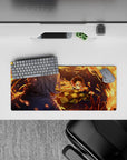 Anime mouse pad 28x12 inches featuring Tanjiro Kamado mid-strike with blazing orange arcs against a deep blue night.