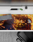 Anime desk pad 36x16 inches featuring Tanjiro Kamado from Demon Slayer, mid-strike with fiery arcs against a deep blue night.