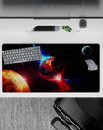 Cinematic space mouse pad 32x16 inches in inky black, violet dust, and electric blue nebula glow.