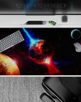 Cinematic deep-space desk pad 40x20 inches in inky black with violet haze, electric blue streaks, and red glow.