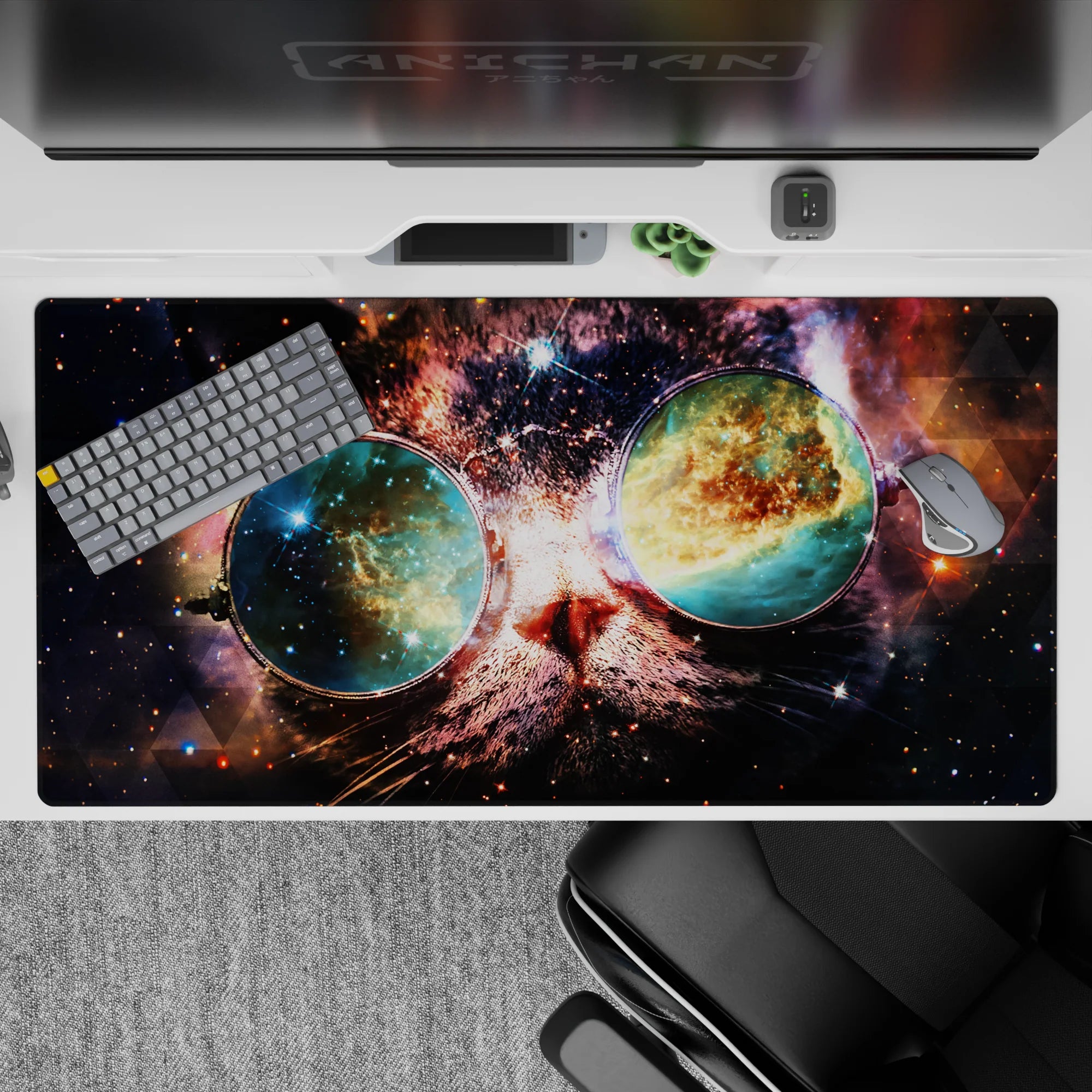 Deep navy and smoky purple desk pad with teal-gold nebula glow, 40x20 inches.