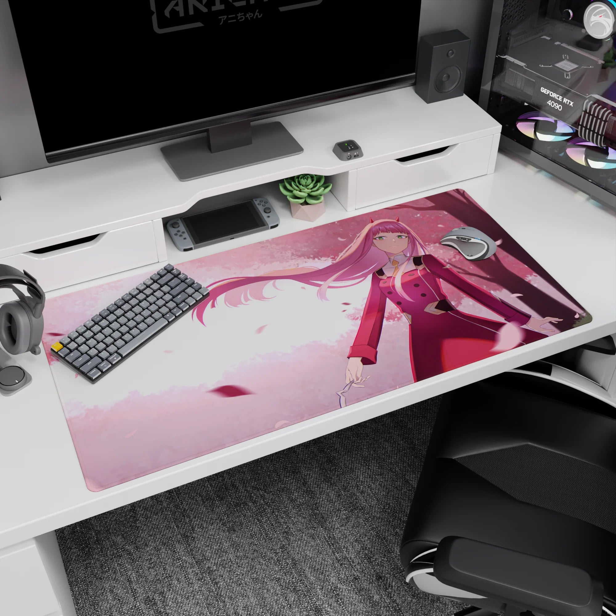 Anime-inspired 40x20 desk mat with cherry blossoms, soft pink tones, and flowing hair, accented by warm golden light