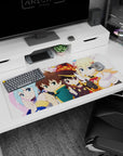 Anime desk pad 36x16 inches featuring Kazuma, Aqua, Megumin, and Darkness from KonoSuba in chibi style, vibrant and fun.