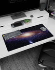 Night sky scene 32x16 inches mouse pad featuring a star-sprinkled galaxy spiral with a soft luminous center.