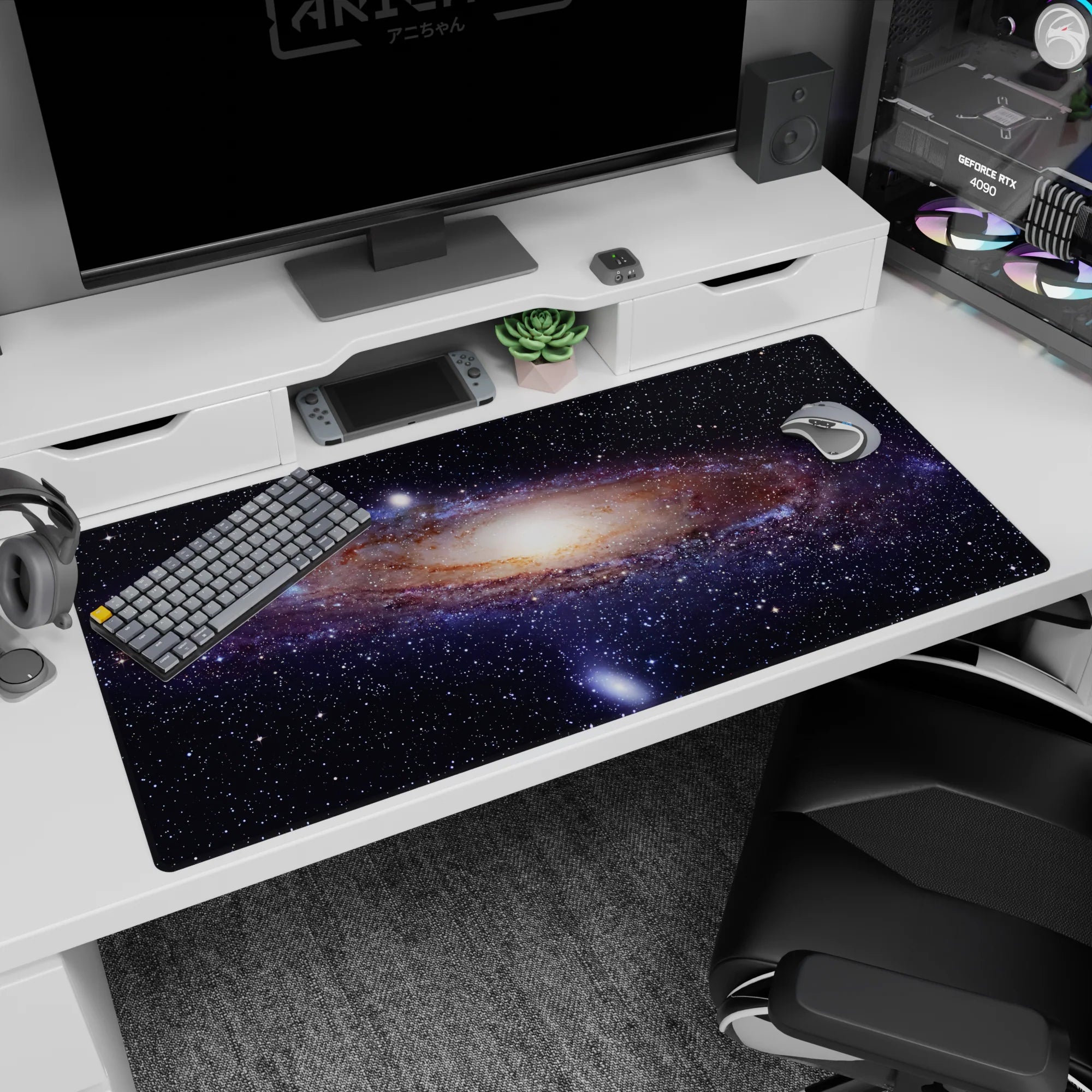 Night-sky ribbon scene on a 40x20 inches desk pad, swirling stars around a glowing center.