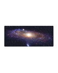 Galaxy swirl starry desk mouse pad 28x12 inches with glowing core and cosmic ribbon design.