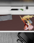 Warm sunset orange, gold, and blush pink anime desk pad 36x16 inches with dreamy protective embrace.