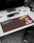 Three anime-style heroes in a protective group hug under sweeping flames on a 36x16 inches desk pad.