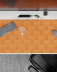Warm tangerine anime desk pad 40x20 inches, bright cozy vibe with cute repeating hamsters.
