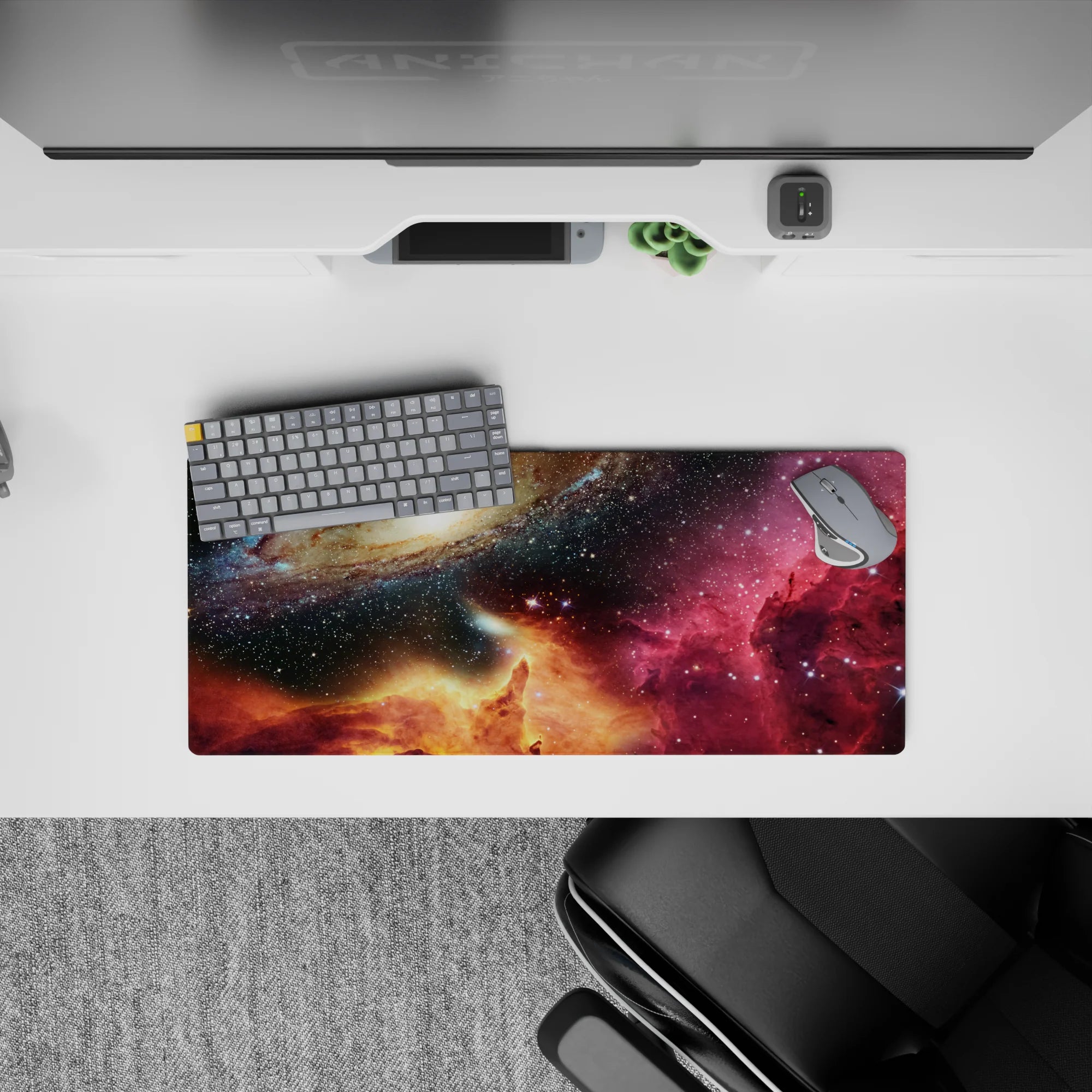 Deep navy and black starfield mouse pad 28x12 inches with magenta nebula haze and golden warmth.