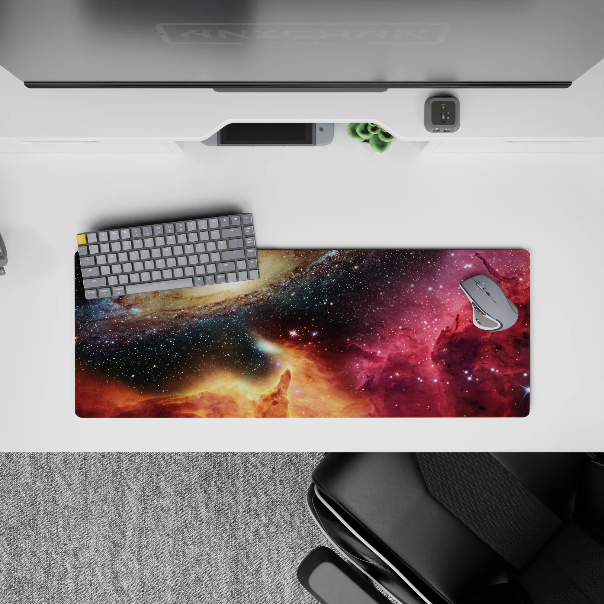 Deep navy and black starfield mouse pad 32x12 inches with magenta nebula wash and warm golden glow.