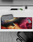 Deep navy and black starfield mouse pad 32x12 inches with magenta nebula wash and warm golden glow.