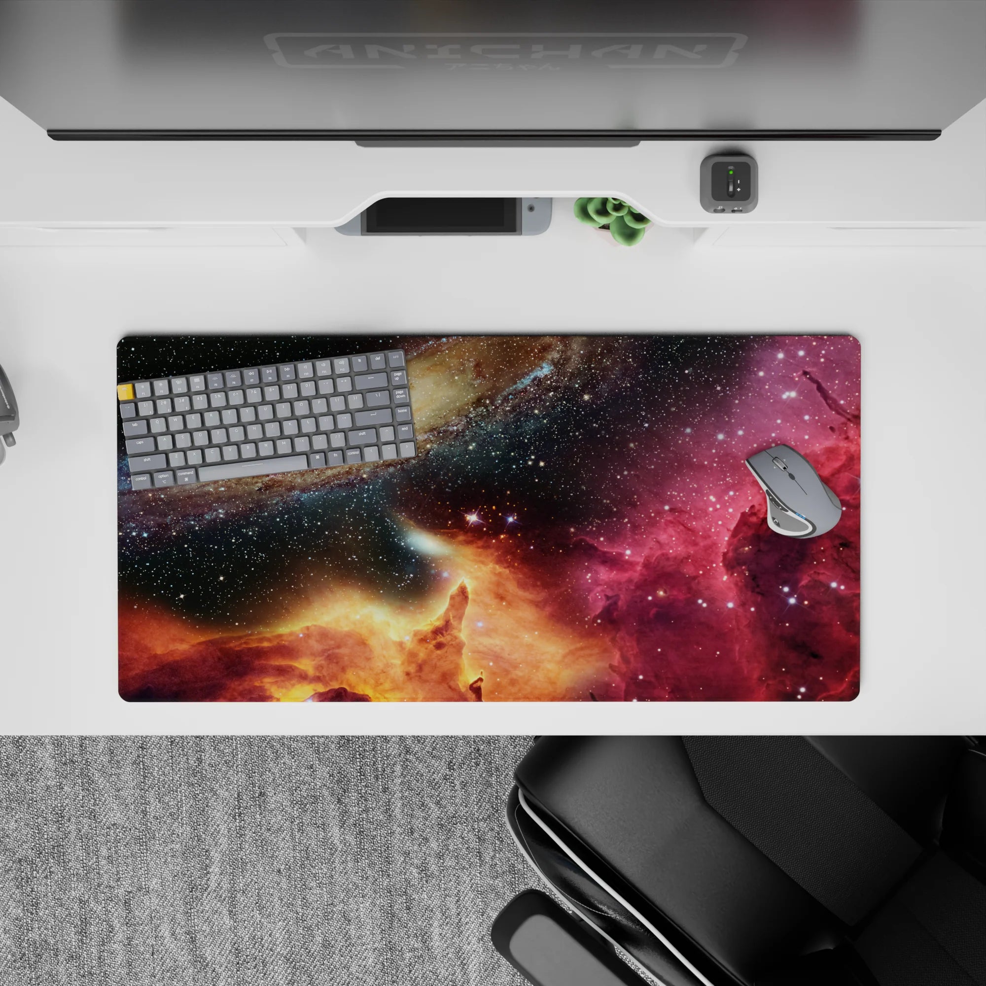 Deep navy and black starfield mouse pad, 32x16 inches, with magenta nebula wash and golden horizon mood.