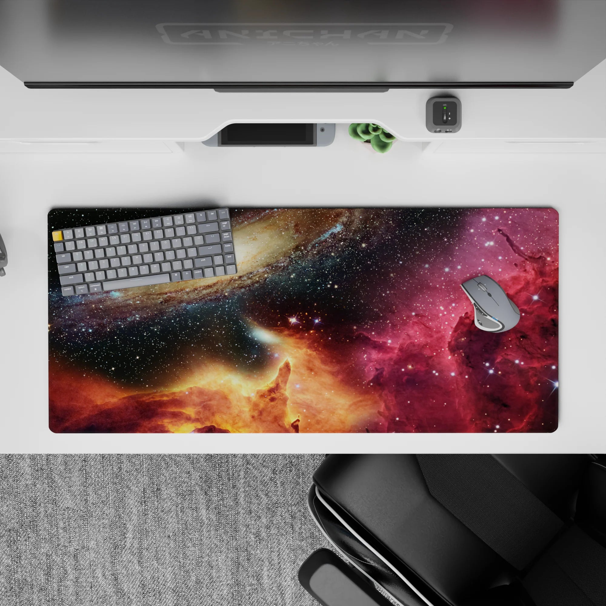 Deep navy and black desk pad 36x16 inches with magenta nebula wash and warm golden glow.