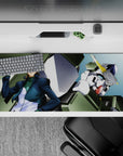 Teal and navy shaded Gundam desk pad 36x16 inches with bright yellow V-fin, cool heroic vibe.