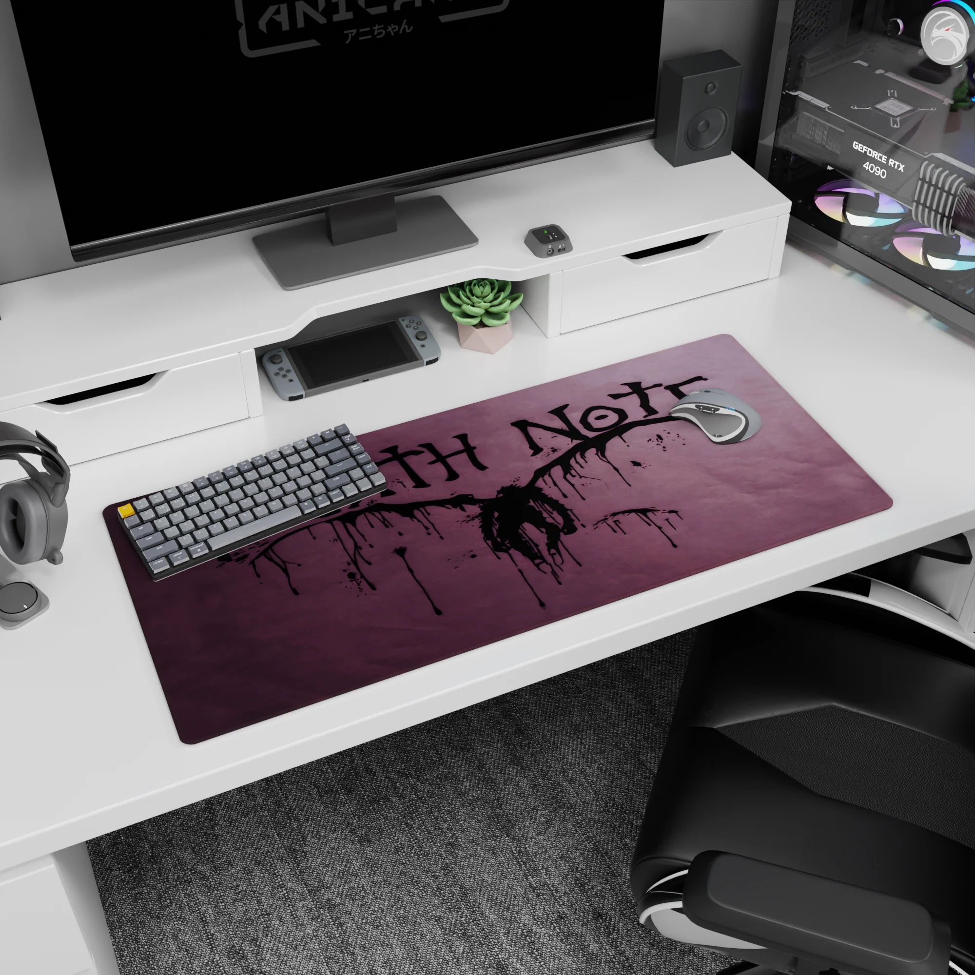 Winged shinigami silhouette centered on Death Note anime desk pad 36x16 inches with splatter lines.